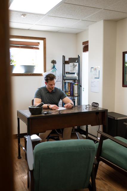Dr. Dawson Sultana working in his Neurvana Health office