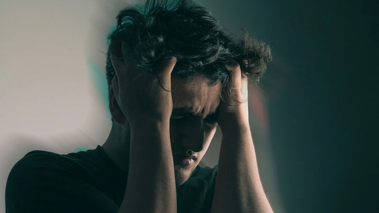Man experiencing brain fog from heavy metal exposure.