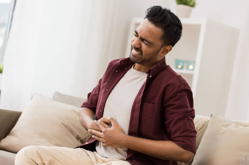 Man suffering from digestion issues from head trauma